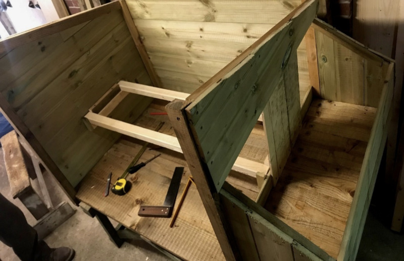 A chicken coop in the process of being built.