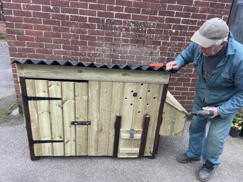 Alan Bright beside one of his chicken coops.